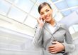 Portrait of beautiful business woman on the phone at modern buil