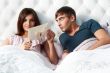 Closeup portrait of a happy young couple relaxing on the bed. Ma