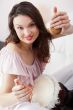 Happy young pretty woman at home, smiling and playing arabic tra