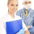 Portrait of Smiling doctor with his colleague in front of the ca