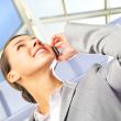 Portrait of beautiful business woman on the phone at modern buil