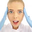 Surprised medical doctor woman. Isolated over white background