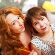 Mother and her daughter sitting together near christmas tree