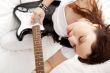 Portrait of beautiful young and attractive womanplaying her guit