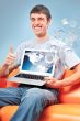 Closeup of a young smiling business man sitting at his home offi