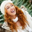 Portrait of young pretty woman in winter park