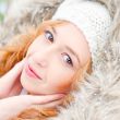 Portrait of pretty girl at winter background wearing warm clothe