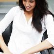 Portrait of a beautiful young woman working on laptop while sitt