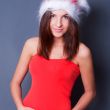 20-25 years od beautiful woman in christmas dress posing against