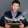 Closeup of a young smiling business man sitting at his office ag