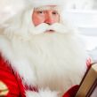 Santa sitting at home and reading a book. Indoors