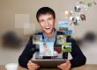 A technology man has images flying away from his modern tablet c