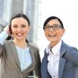 Portrait of two businesswomen outside.