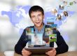 Portrait of young happy man sharing his photo and video files in