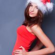 20-25 years od beautiful woman in christmas dress posing against
