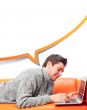 Portrait of young handsome student man laying on sofa using lapt