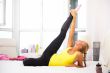 Portrait of beautiful young woman doing exercise at her home