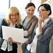 Closeup portrait of three women working indoor together with doc