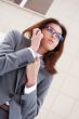 Beautiful business woman on the phone at modern building. Outdoo