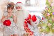 Christmas theme: Santa Claus and little girl having a fun. Indoo