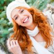 Portrait of young pretty woman in winter park 