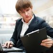 Portrait of handsome young man working with laptop at cafe at bu
