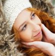 Portrait of pretty girl at winter background wearing warm clothe