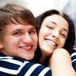 Young man meeting his girlfriend and embracing at airport arriva