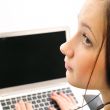 Young business woman on a laptop from behind