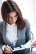 Portrait of an adorable business woman working at her desk with 