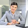 Young business woman on a laptop at her office
