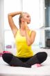 Portrait of beautiful young woman doing exercise at her home