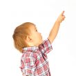 Portrait of happy little boy over white background looking away 