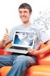 Closeup of a young smiling business man sitting at his home offi