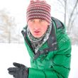 Closeup portrait of young man running in winter park