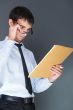 Closeup of a young smiling business man standing confidently aga
