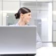 Young business woman on a laptop at her office. Looking Away