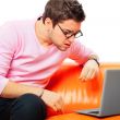 Closeup portrait of young man using laptop