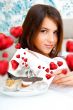 Delighted woman reading a greeting card sitting on the sofa at h