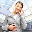 Portrait of beautiful business woman on the phone at modern buil
