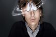 Young Business man against gray background. Distorted head and c