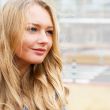 Closeup portrait of a beautiful woman in the city at summer time