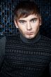 Fashion portrait of the young beautiful man inside luxury glamor
