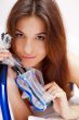 Young woman in bed holding diving mask and dreaming about vacati