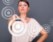 Portrait of a beautiful fashionable elegant woman with remote co