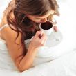 Fashion portrait of young elegant woman in bed