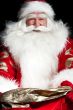 Santa sitting at the Christmas room and looking into the sack