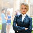 Portrait of a cute business woman with colleagues at the backgro