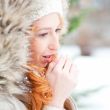 Portrait of pretty girl at winter background wearing warm clothe