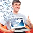 Portrait of handsome young man holding laptop computer and worki